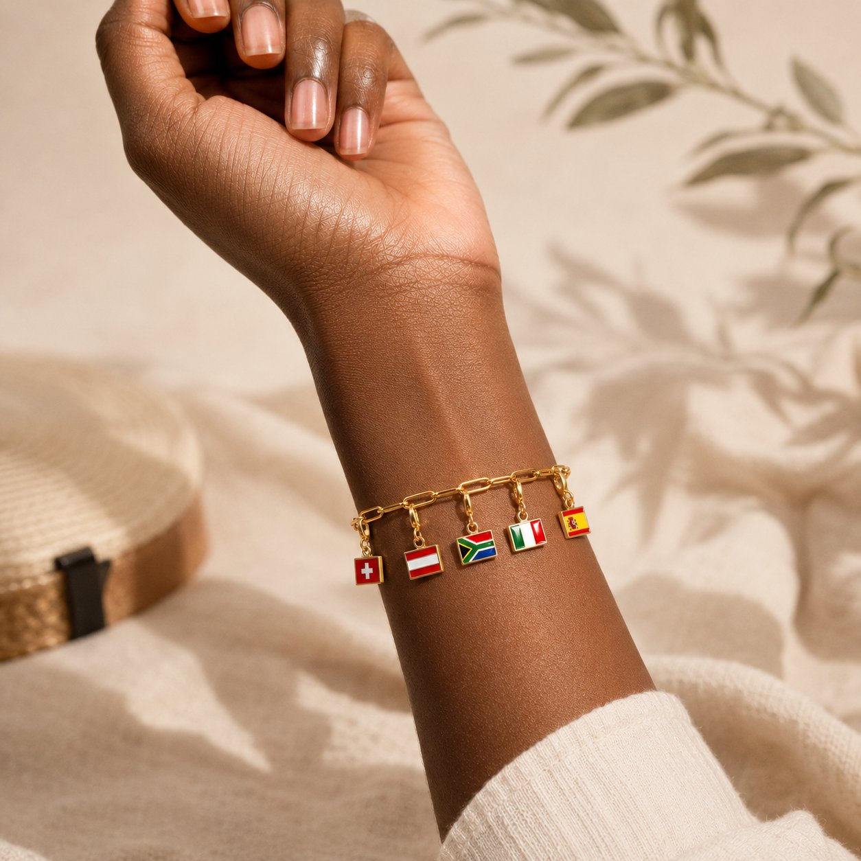 Gold charm bracelet with flag charms